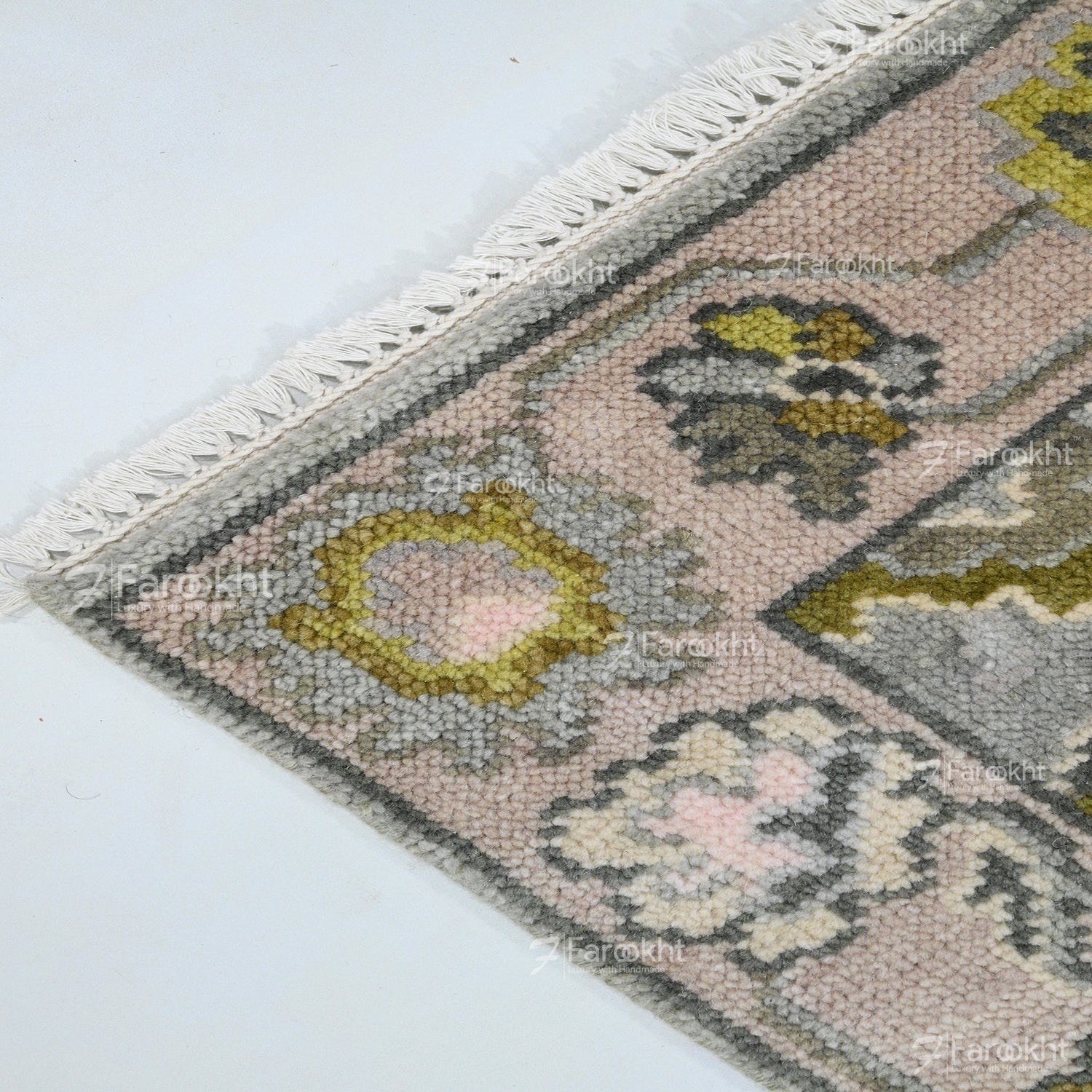 Close-up of a patterned rug with geometric design on a white background