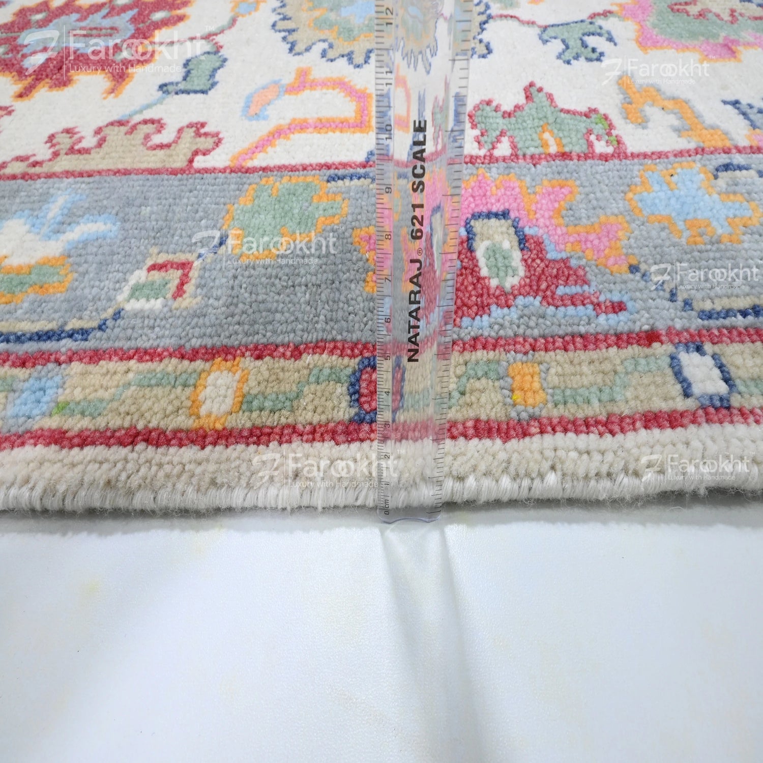 Close-up of a colorful patterned fabric with measurement scale on a white background