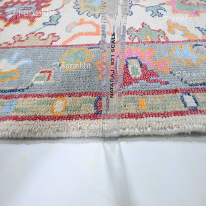 Close-up of a colorful patterned fabric with measurement scale on a white background