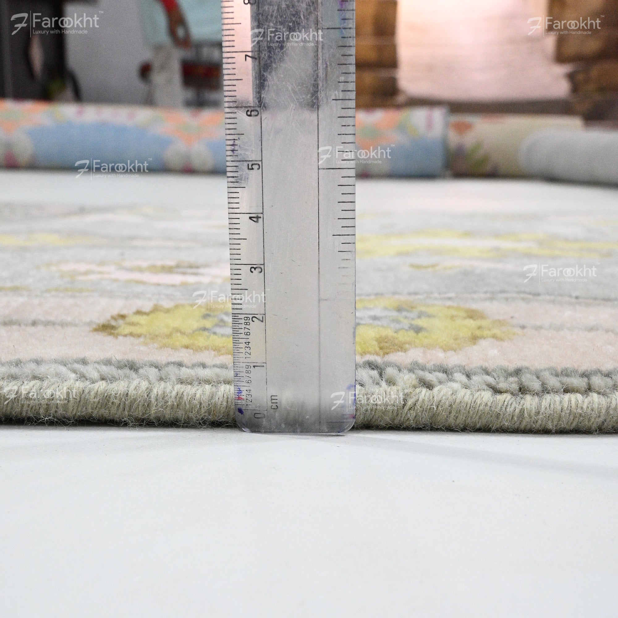 Rug with a ruler for scale on a white surface