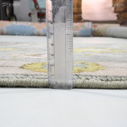 Rug with a ruler for scale on a white surface