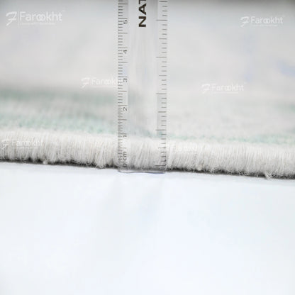 Close-up of fabric with a ruler for scale, branded &