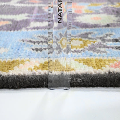 Colorful textured fabric with a ruler for scale on a white background