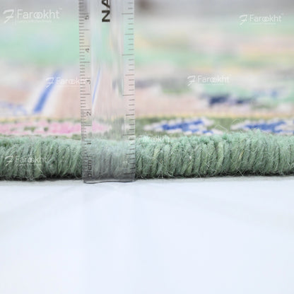 Close-up of a green carpet with a ruler for scale on a blurred background