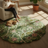 Handcrafted round floral area rug in sage green and blush tones made from soft premium wool.