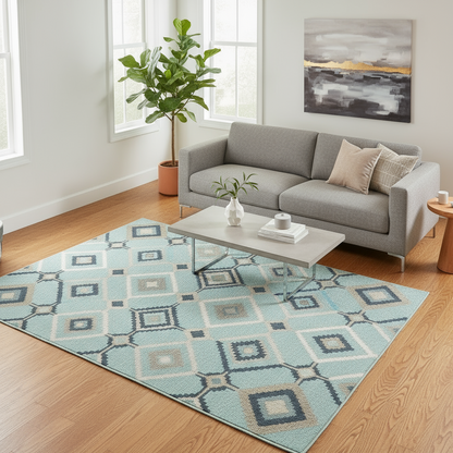 Living room with a gray sofa, patterned rug, and decorative items.